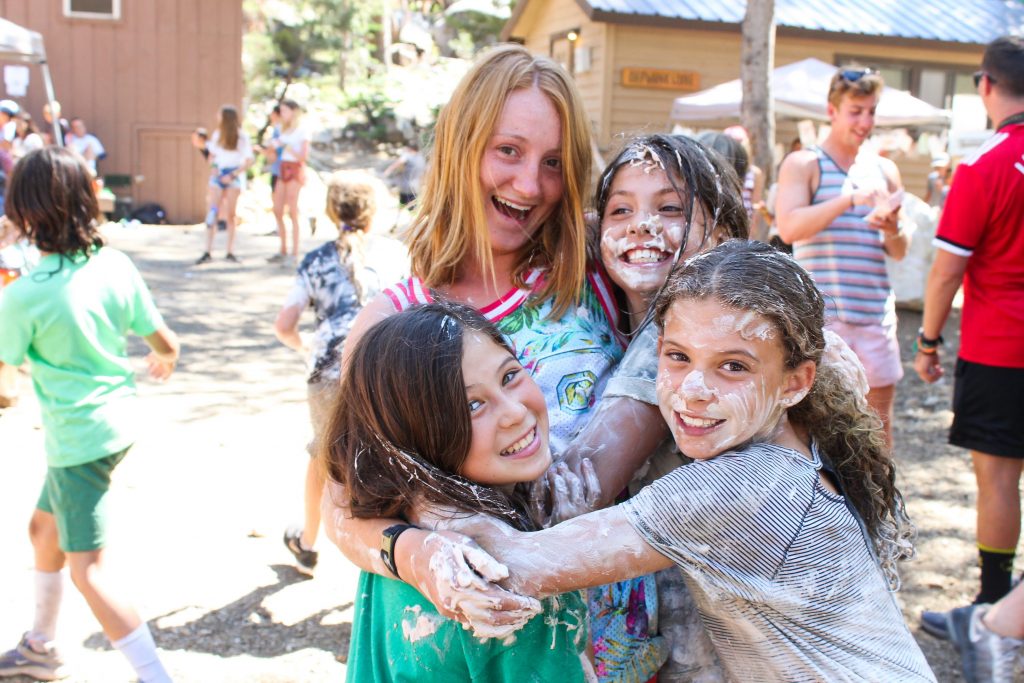 Summer Camp campers having fun at the carnival with a counselor.