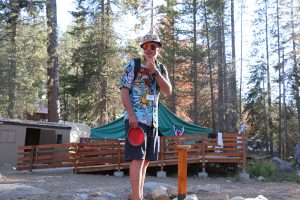 Simba, a summer camp counselor at Gold Arrow Camp poses on the disc golf course in California